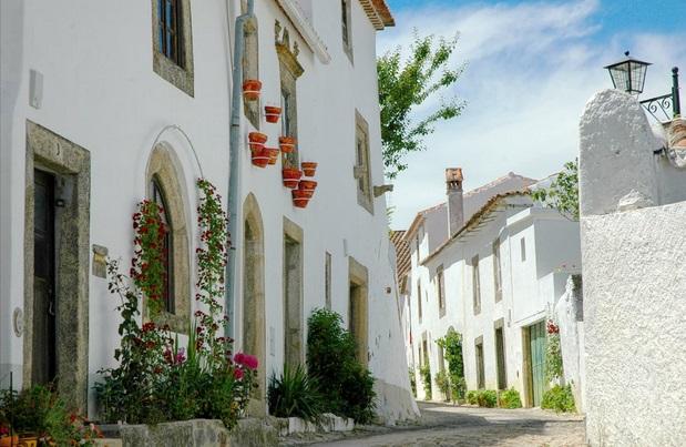 White houses and blue sky on a quiet street in Marvão, Portalegre, Portugal