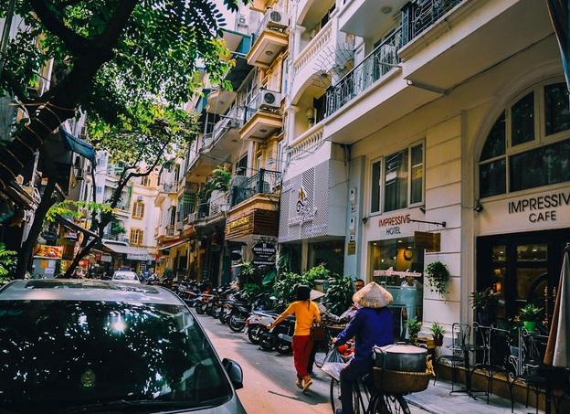 People walking on a narrow city street in Vietnam’s capital, Ho Chi Minh City